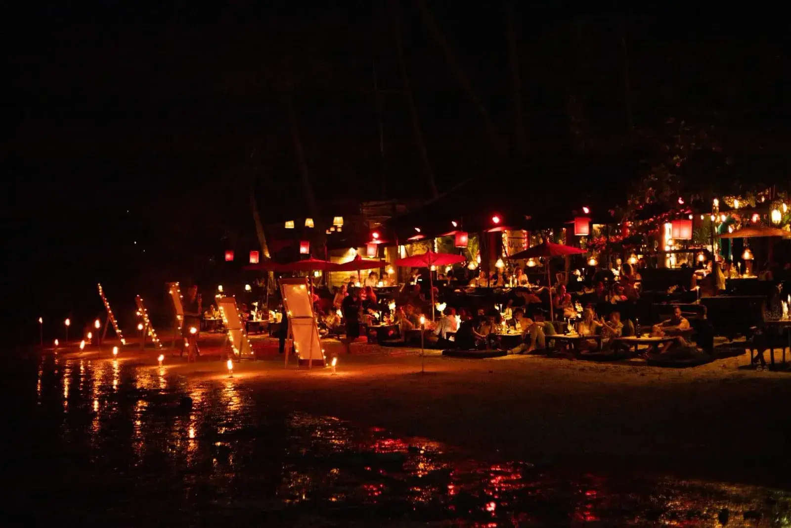 A candlelit dinner by the shore at night